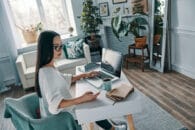 Discover Working from home. Young woman working using laptop while sitting in home office Discover-Working-From-Home-content.Image-